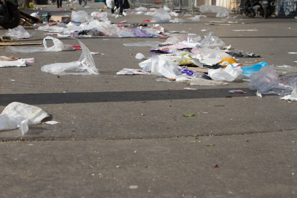 istock plastics and paper polluting streets and flying through the pavements 1309292509