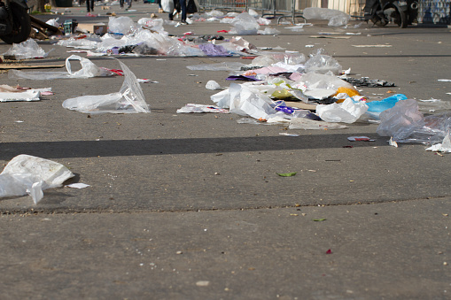 junk of plastics and paper polluting streets and flying through the pavements in Europe
