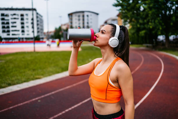 istock Woman runner drinking water 1309293858