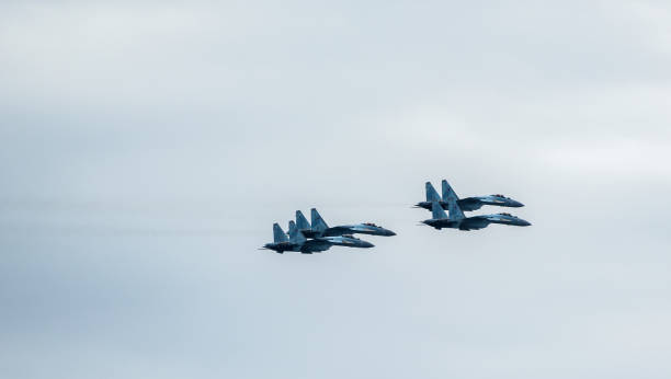 A group of Russian Knights of four Su-35 in the sky over the city during the celebration of the Day of the Navy. Vladivostok, Russia - July 26, 2020: A group of Russian Knights of four Su-35 in the sky over the city during the celebration of the Day of the Navy. supersonic airplane editorial airplane air vehicle stock pictures, royalty-free photos & images