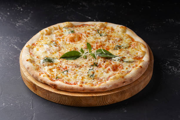istock Pizza 4 cheeses on a dark concrete background. 1309299436