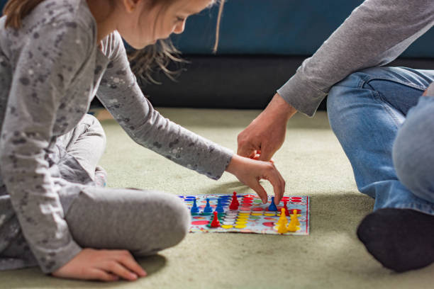 istock Close-up of human hands playing board game 1309300513