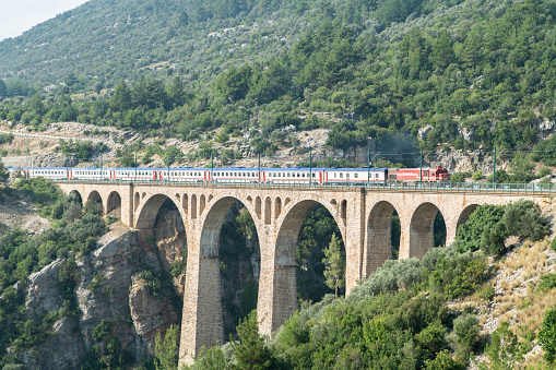 Adana, Turkey - August 31, 2019 : Historical Varda Bridge in Adana, Turkey. Train passing over railroad.