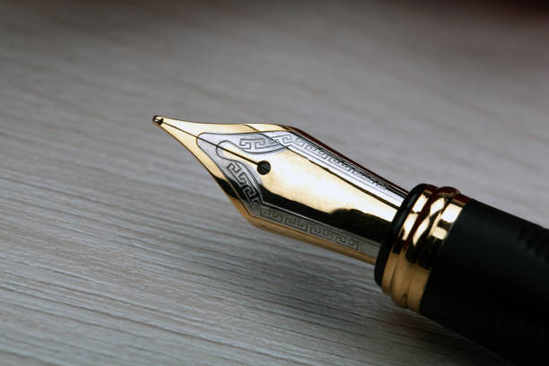 istock gold plated fountain pen closeup on the table 1309301072