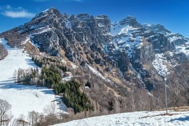 istock Mount Resegone with snow and a blue sky 1309301165
