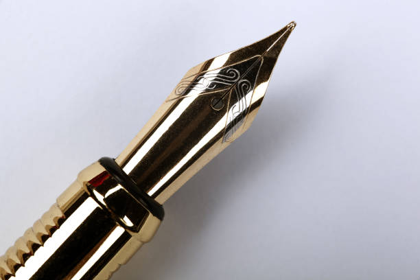 istock gold plated fountain pen closeup on the table 1309301935