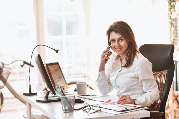 istock Female Enjoying Her Office Business Work And Talking On Smartphone 1309302002