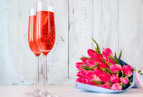 Glasses of champagne with bouquet of tulips