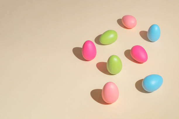 istock 2021 Easter bold and minimal still life composition. Colorful eggs arranged on beige background. Trendy minimal concept. 1309303119