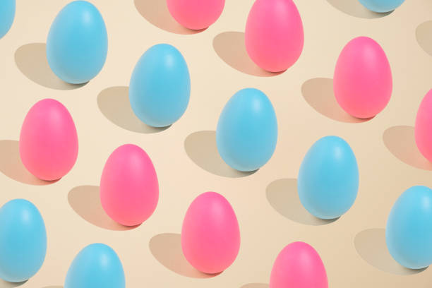 istock 2021 Easter bold and minimal still life composition. Pink and blue eggs arranged on beige background. Trendy minimal concept. 1309303122