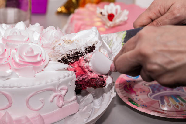 istock a woman cuts a cake with a knife 1309303416