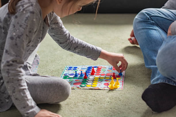 istock Close-up of human hands playing board game 1309304162