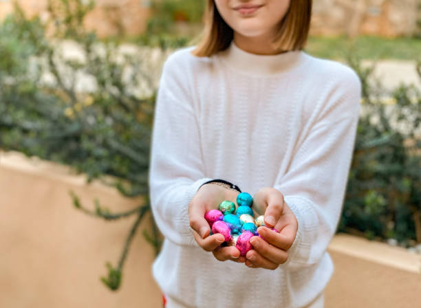 istock little girl holding chocolate easter eggs with her hands 1309305323