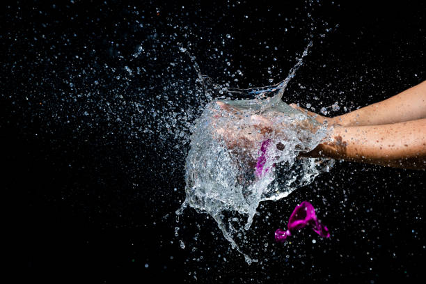 istock Water balloon bursting in hands 1309305328