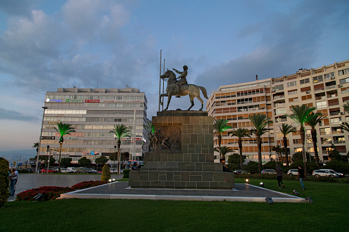 izmir, Turkey - September 26, 2019 : Atatürk Statue at sunset in Izmir, Turkey. The municipality and governorship of İzmir decided to build a monument dedicated to Great Leader Mustafa Kemal Ataturk, the founder of modern Turkey. In 1929, the statue of the monument was commissioned to Pietro Canonica an Italian sculptor who had formerly created another Ataturk statue in istanbul in 1928. The base of the statue was designed by Turkish architect Asim KOMURCU and the statue was erected on 27 July 1932.