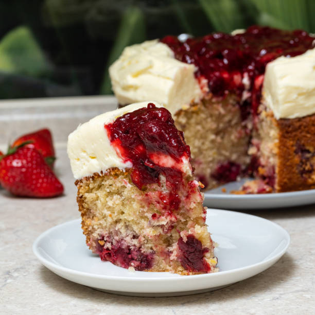 istock cherry cake with cream cheese and cherries on cream, on a stone table top on a background of strawberries. 1309305739