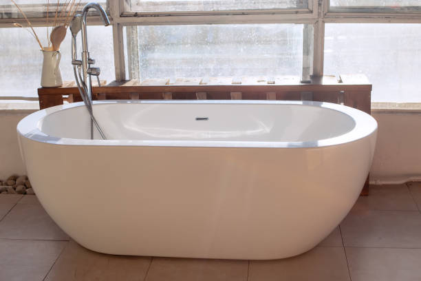 istock Large white bath near a large window , in an industrial style 1309305833