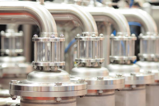 istock Industrial highly glossy stainless steel pipe connection on pipework 1309307024
