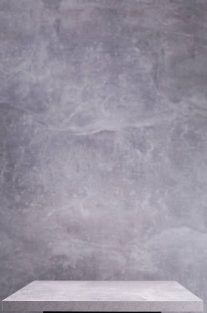 istock Wooden book shelf at abstract wall background or putty texture. Front view of tabletop 1309307864
