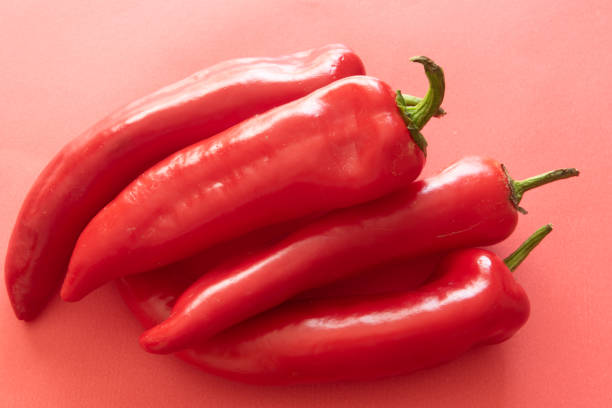 istock Fresh Sweet Red Peppers on a bright red background 1309308356