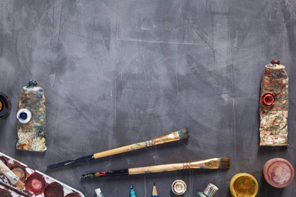 istock Paintbrush and tubes with painter tools at abstract table background texture. Art painter concept 1309309269