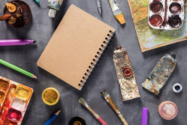 Paintbrush and tubes with painter tools at abstract table background texture. Art painter concept