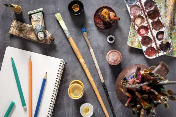 istock Paintbrush and tubes with painter tools at abstract table background texture. Art painter concept 1309309292