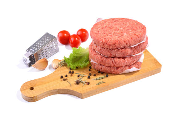 istock Raw beef patties for making a burger.Isolated on a white background.Selective Focus. 1309309553