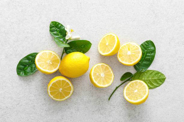 istock Lemons. Fresh juicy lemons with leaves on white background 1309310531
