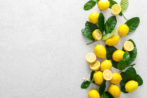 istock Lemons. Fresh juicy lemons with leaves on white background 1309310576