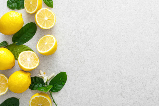 istock Lemons. Fresh juicy lemons with leaves on white background 1309310596