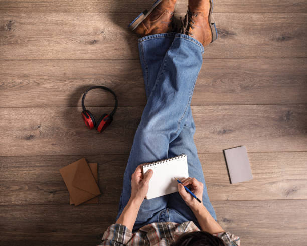 istock Men's hand holding pencil and notebook. Man student writing or drawing by pencil 1309311755