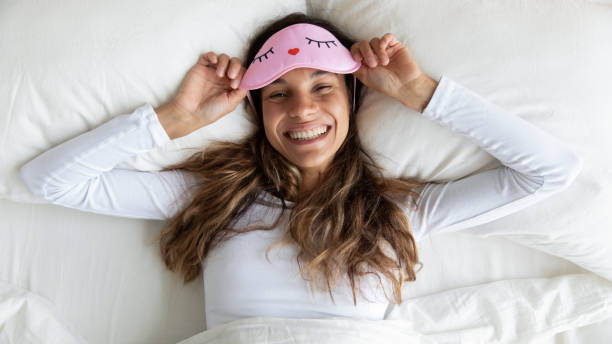 istock Top view happy attractive woman wearing sleeping mask relaxing 1309312519