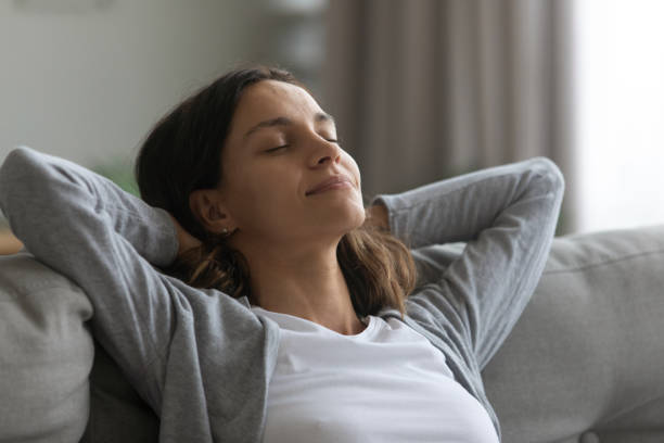 istock Close up satisfied attractive woman resting on couch alone 1309312570