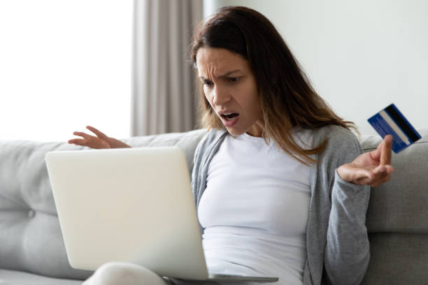 istock Close up unhappy woman having problem with credit card 1309312590