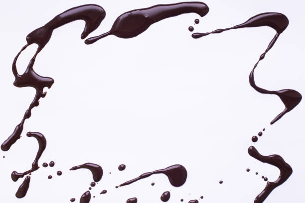 istock light gray background with a frame of spilled liquid chocolad 1309312690