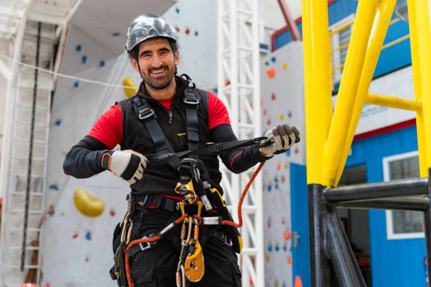 istock Smiling young mountaineer male preparing for the climb 1309313897