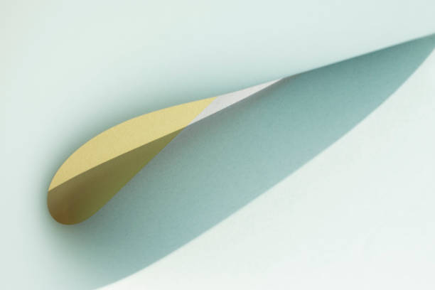 istock Macro image of blue and yellow paper with shadow effect and selective focus. 1309314249