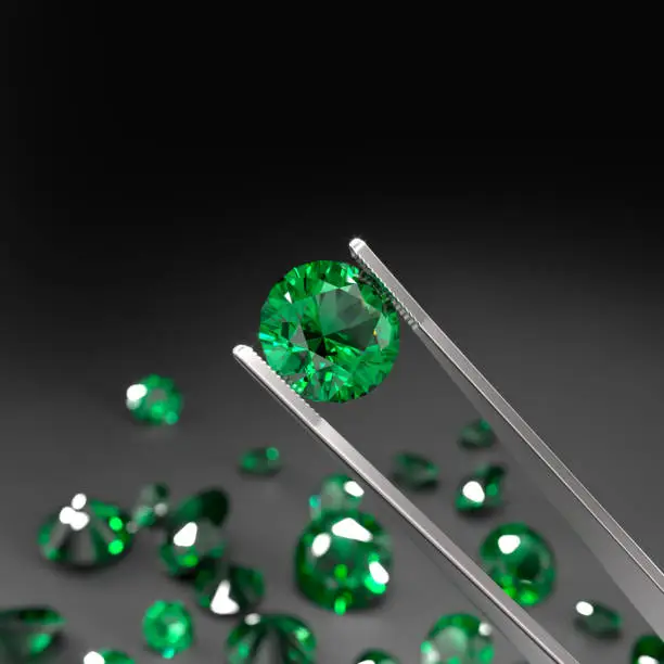 Tweezers are holding an emerald. A scattering of emeralds on a black surface. Gemstone Industry. Expertise for genuineness. 3d rendering.