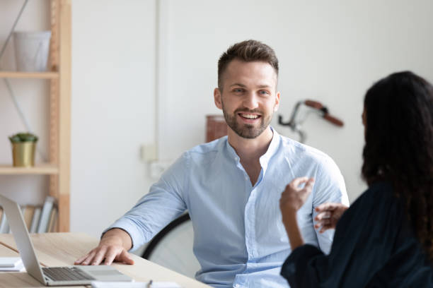 istock Smiling diverse colleagues brainstorm at team meeting 1309314979