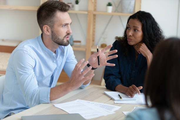 istock Motivated diverse colleagues discuss paperwork at meeting 1309314994