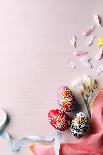 Easter eggs and flowers. Background with copy space.