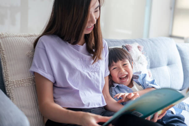 istock Adoring mom reading book with her toddler son at home 1309316043