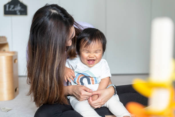 istock Adorable ethnic baby laughing while playing with mom 1309316051