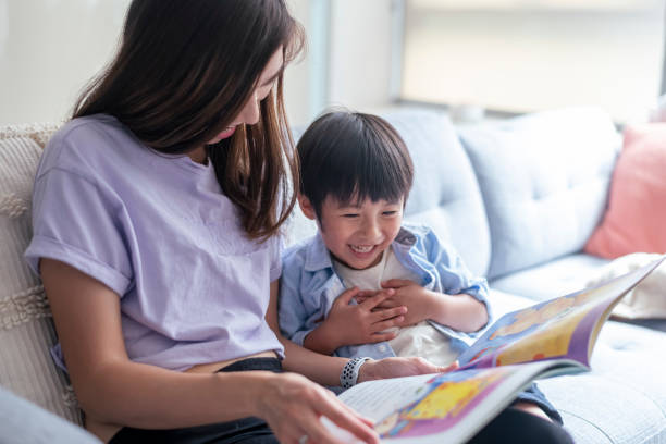 istock Adoring mom reading book with her toddler son at home 1309316058