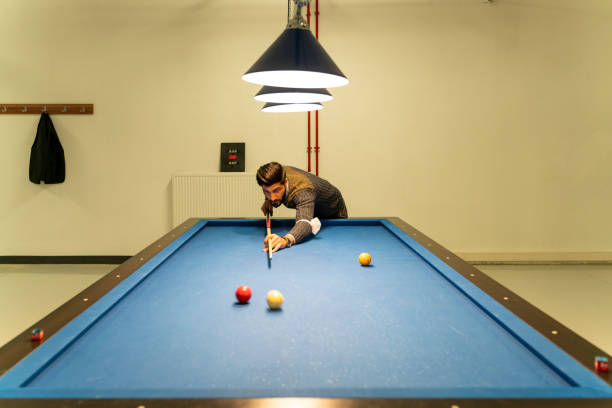 istock Officer playing billiards in office building living area 1309316323
