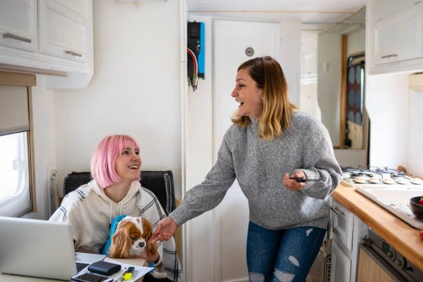 istock Two women with their dog laughing in their caravan 1309316492