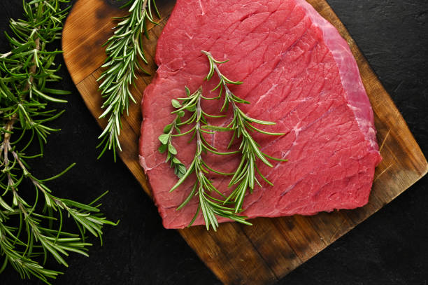 istock Raw fresh angus meat on a cutting board with rosemary 1309318520