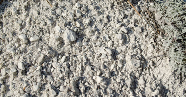 istock Small stones of natural chalk. Chalk mountain texture. Native chalk. Chalk mining background or natural natural white background 1309321122