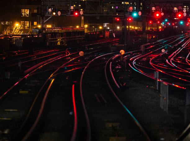 istock Railway tracks illuminated at night in the city 1309322133